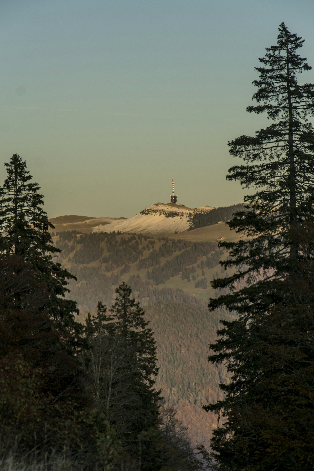 a view of a mountain with a tower in the distance