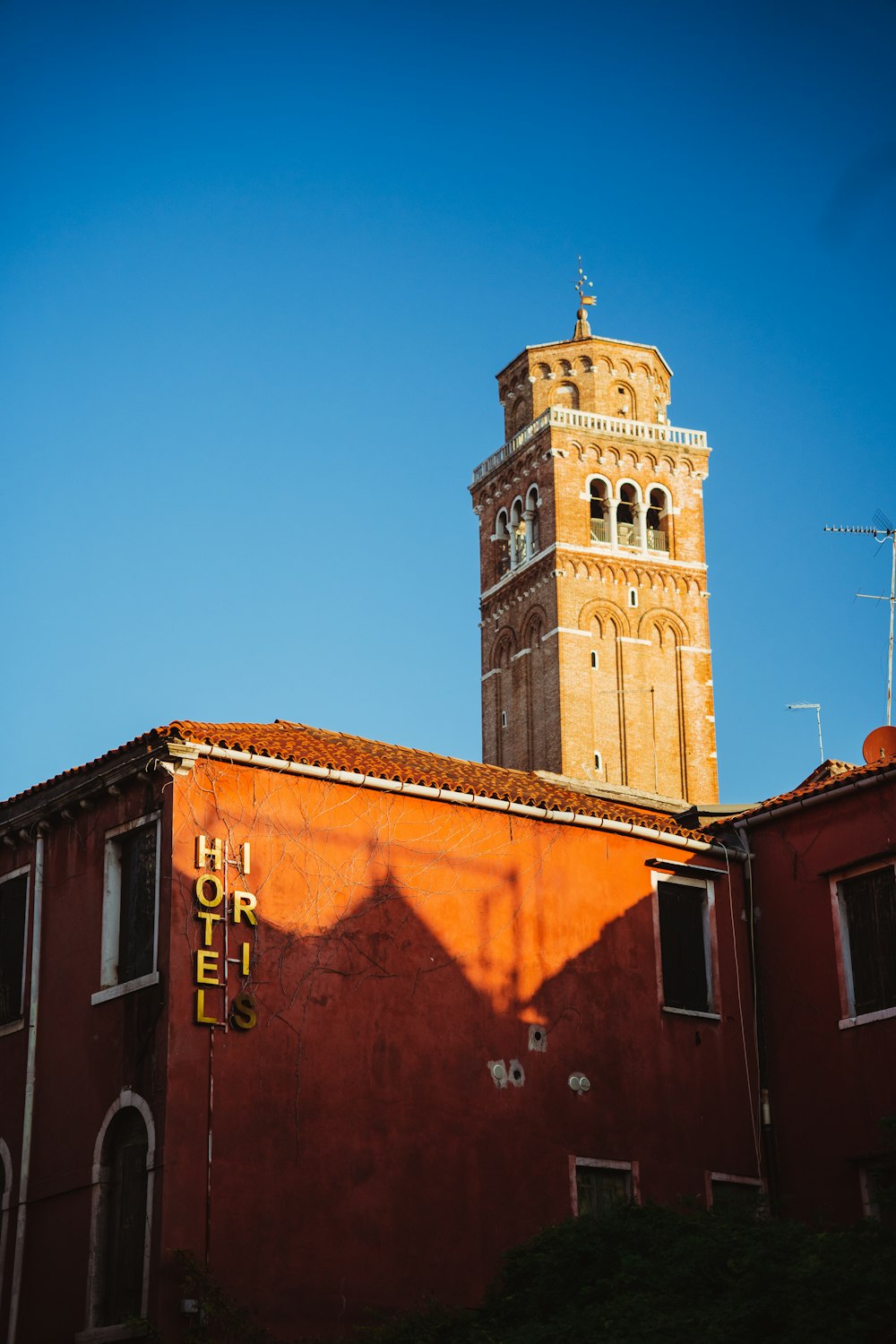 a red building with a clock tower in the background