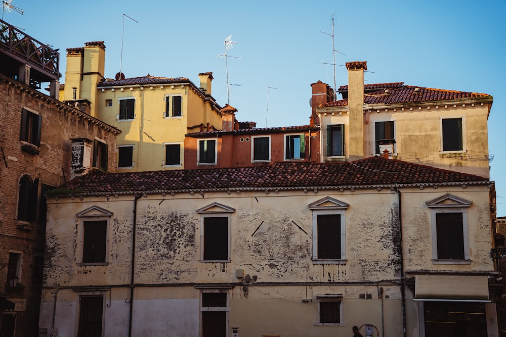 a row of buildings with windows and a bench in front of them