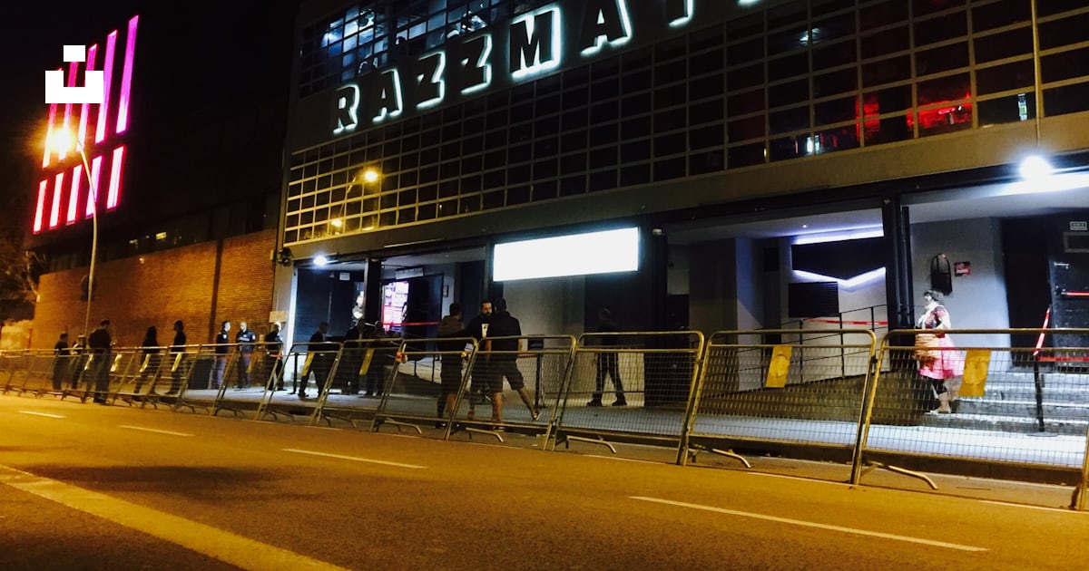 A group of people standing outside of a building at night photo Free Carrer dels almogàvers A group of people standing outside of a building at night photo Free Carrer dels almogàvers