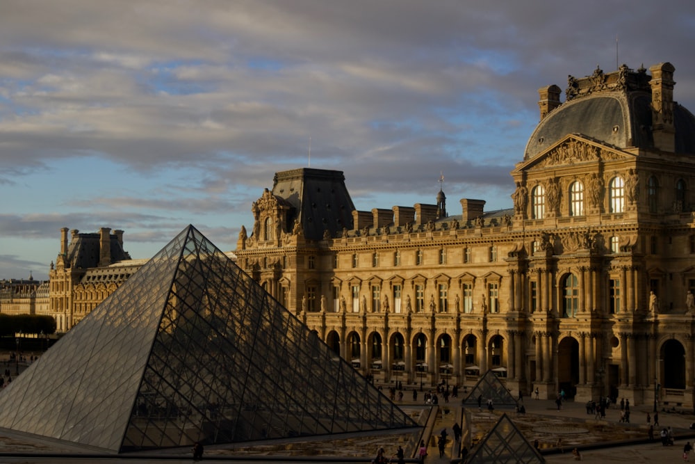 a large building with a pyramid in front of it