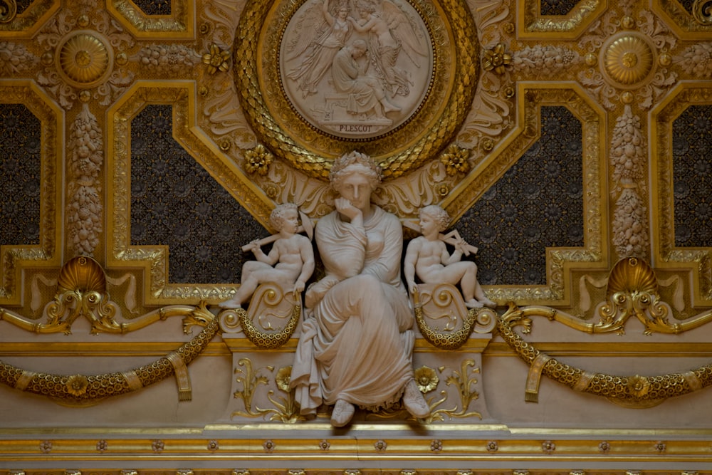 a statue of a woman surrounded by two cherubs