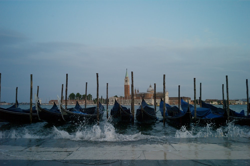 a row of gondolas sitting next to a body of water