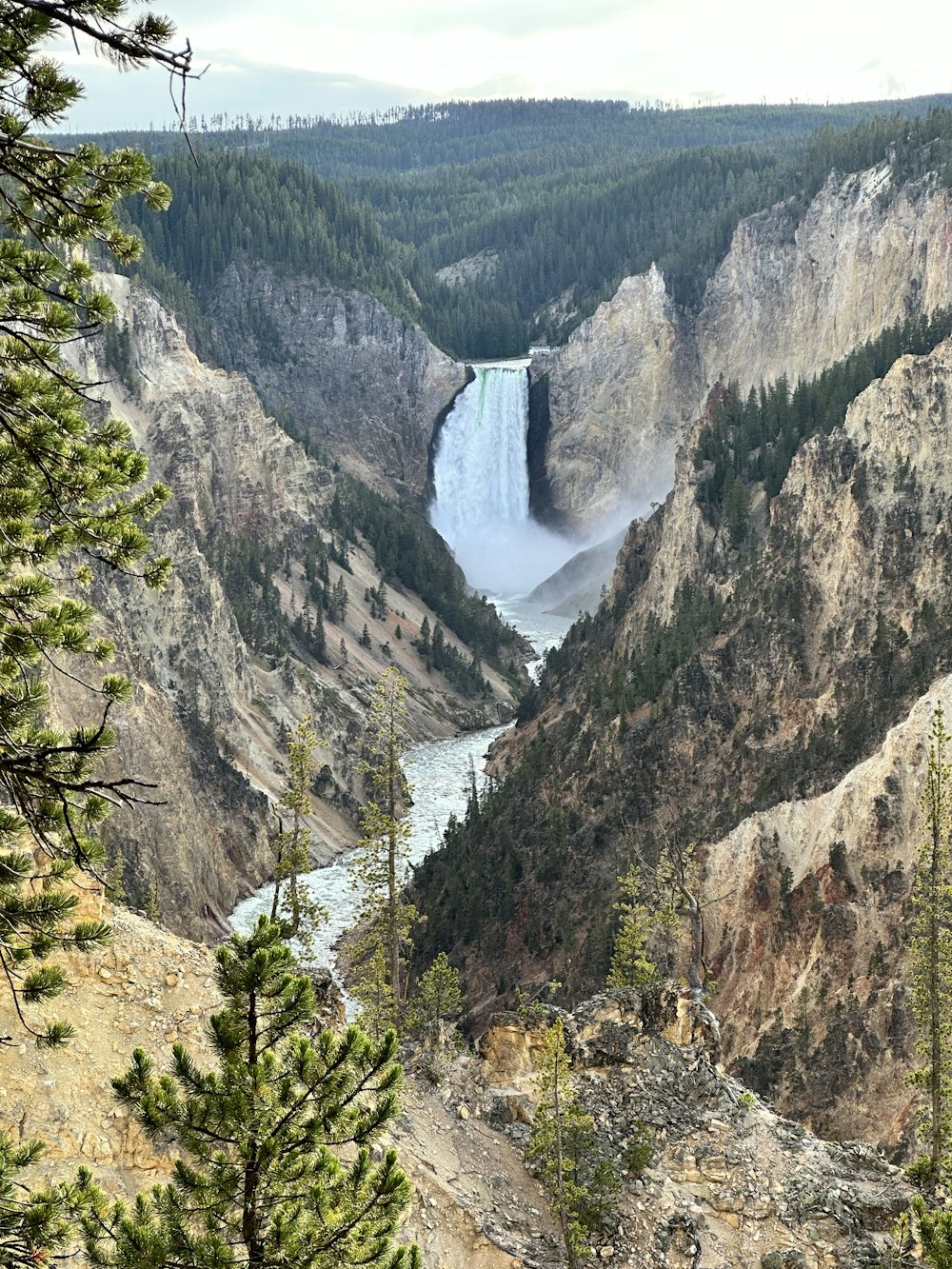 a view of a large waterfall in the mountains