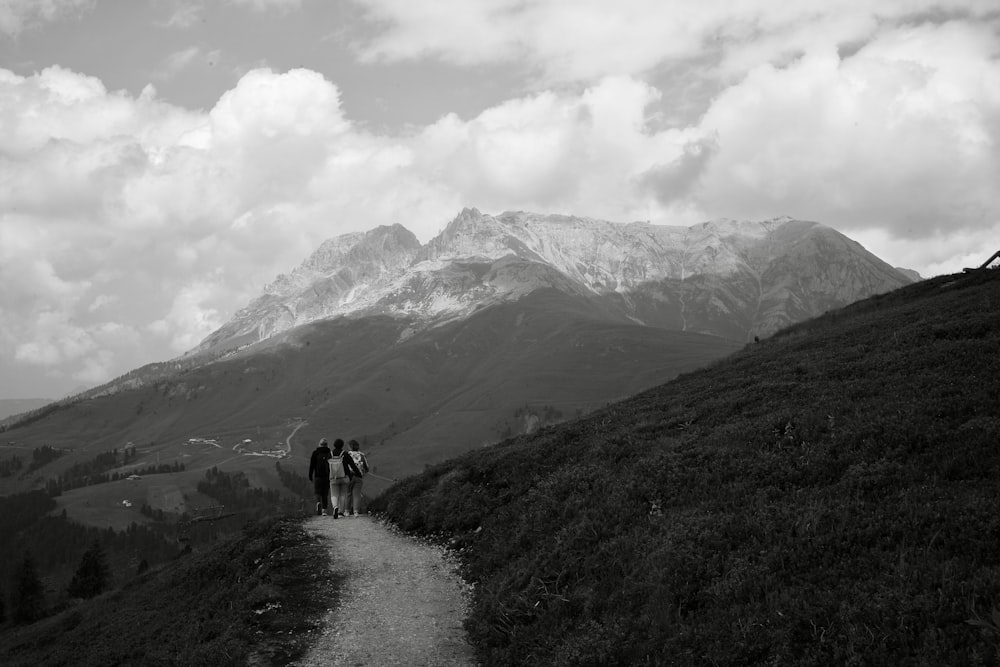 a couple of people that are standing on a trail