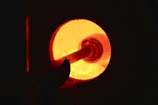Steel furnace glowing orange with coke fueling the intense heat inside.