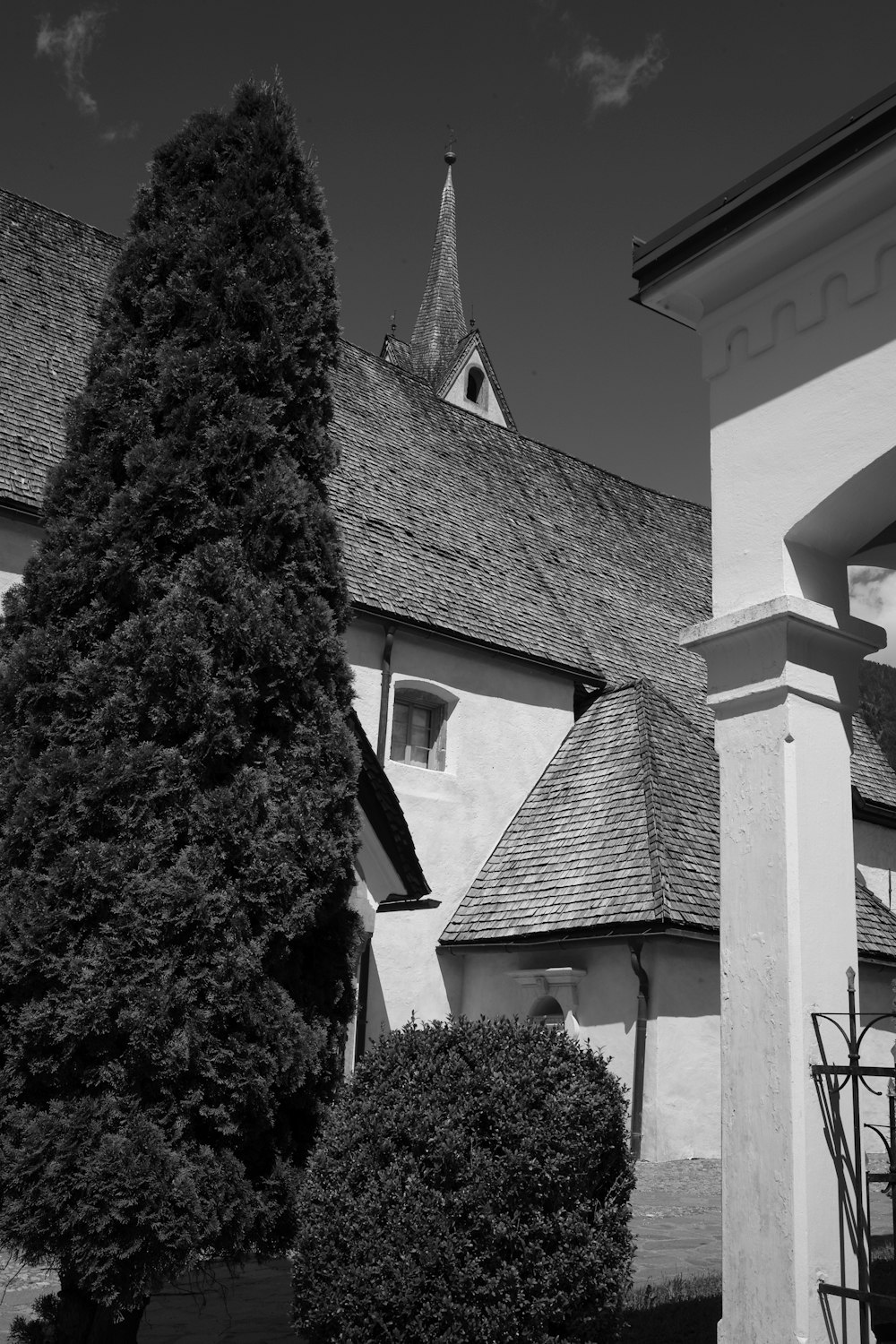 a black and white photo of a building with a steeple