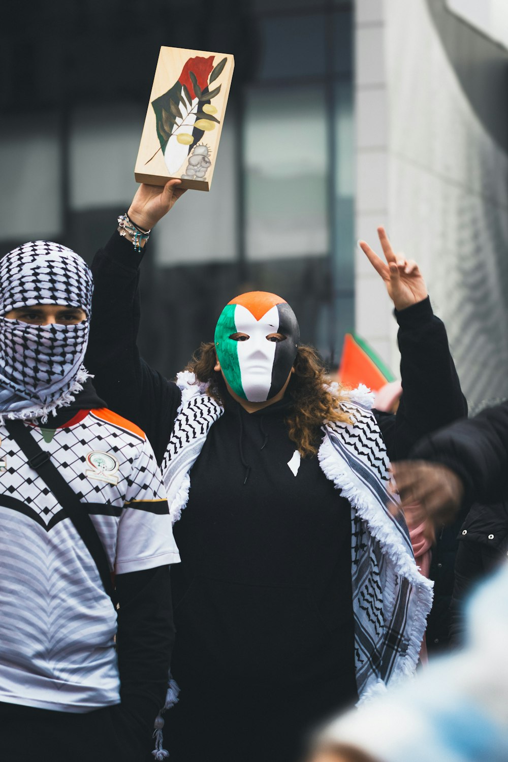 a group of people wearing masks and scarves