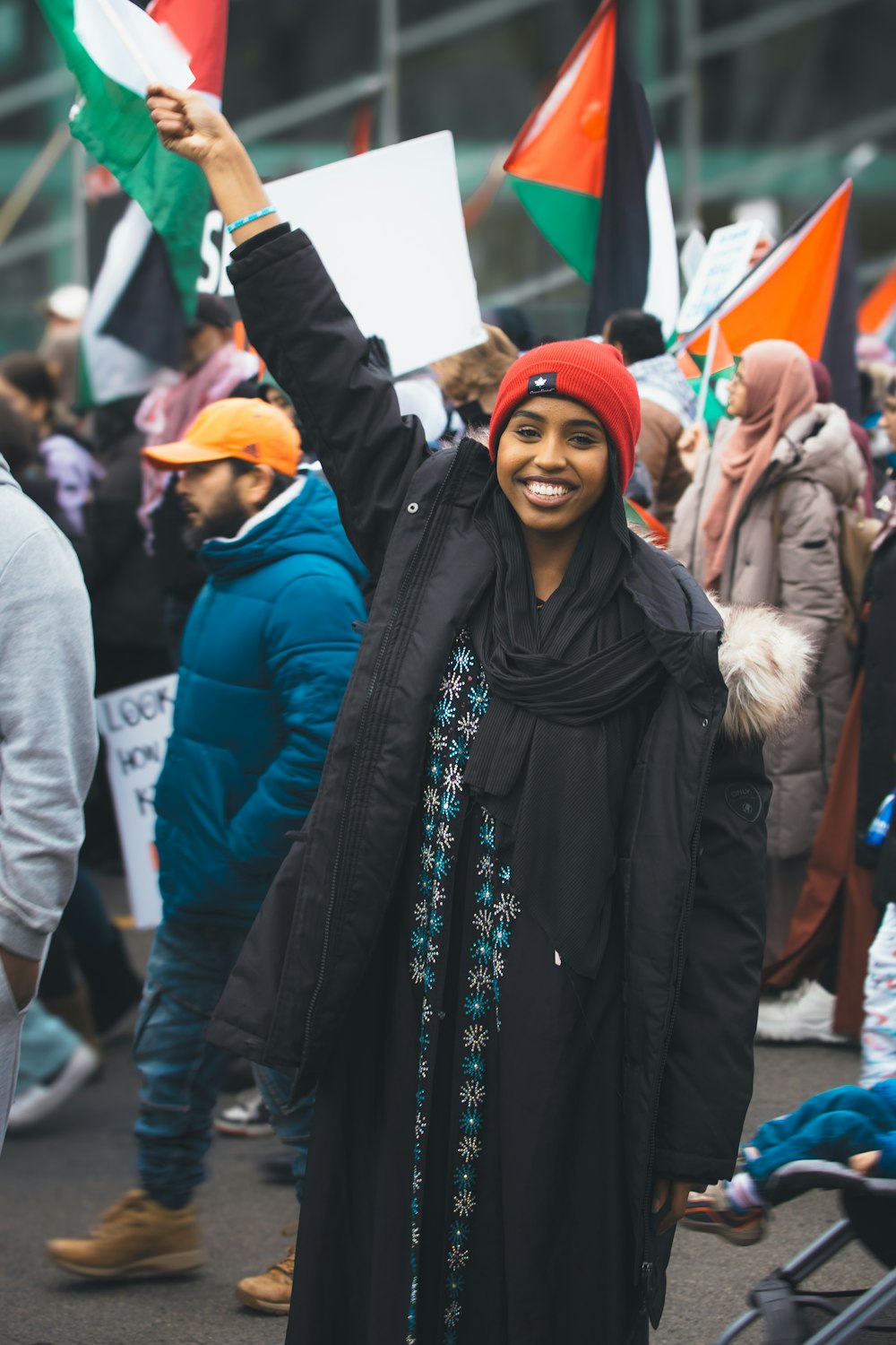 a woman holding a flag in a crowd of people