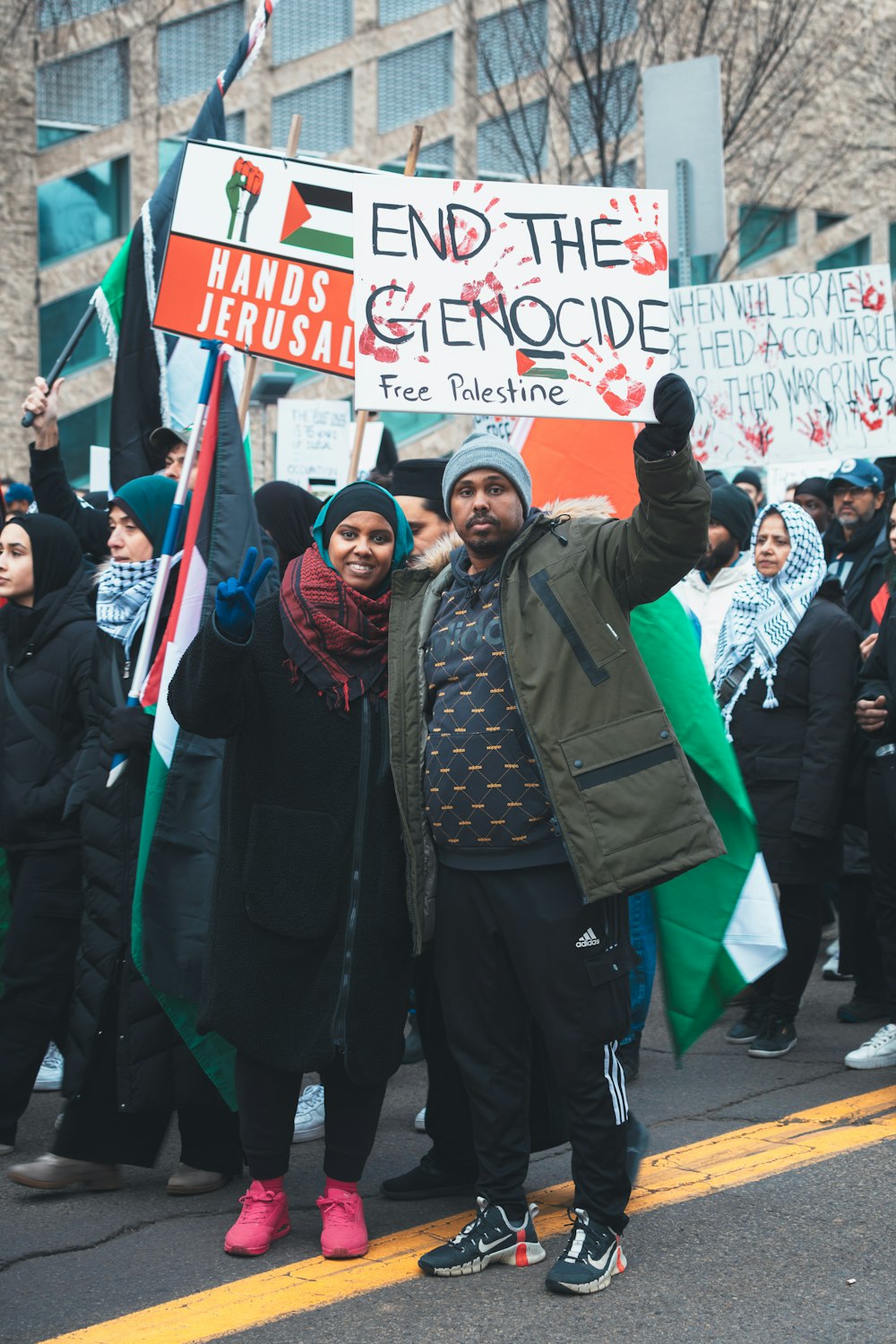 a group of people standing on a street holding signs