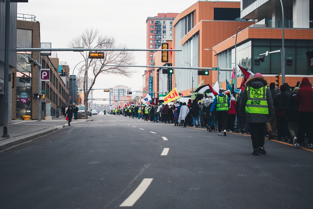 a group of people standing on the side of a road