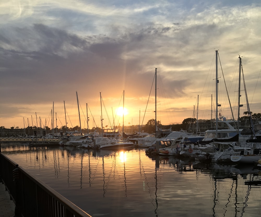 a harbor filled with lots of boats under a cloudy sky