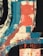 An abstract painting featuring bold, wide brushstrokes in black, blue, and red overlapping a textured beige surface. The composition is dynamic, with sweeping arcs and intersecting rectangles creating a sense of movement.