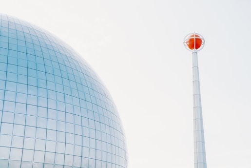 a red traffic light sitting next to a tall building