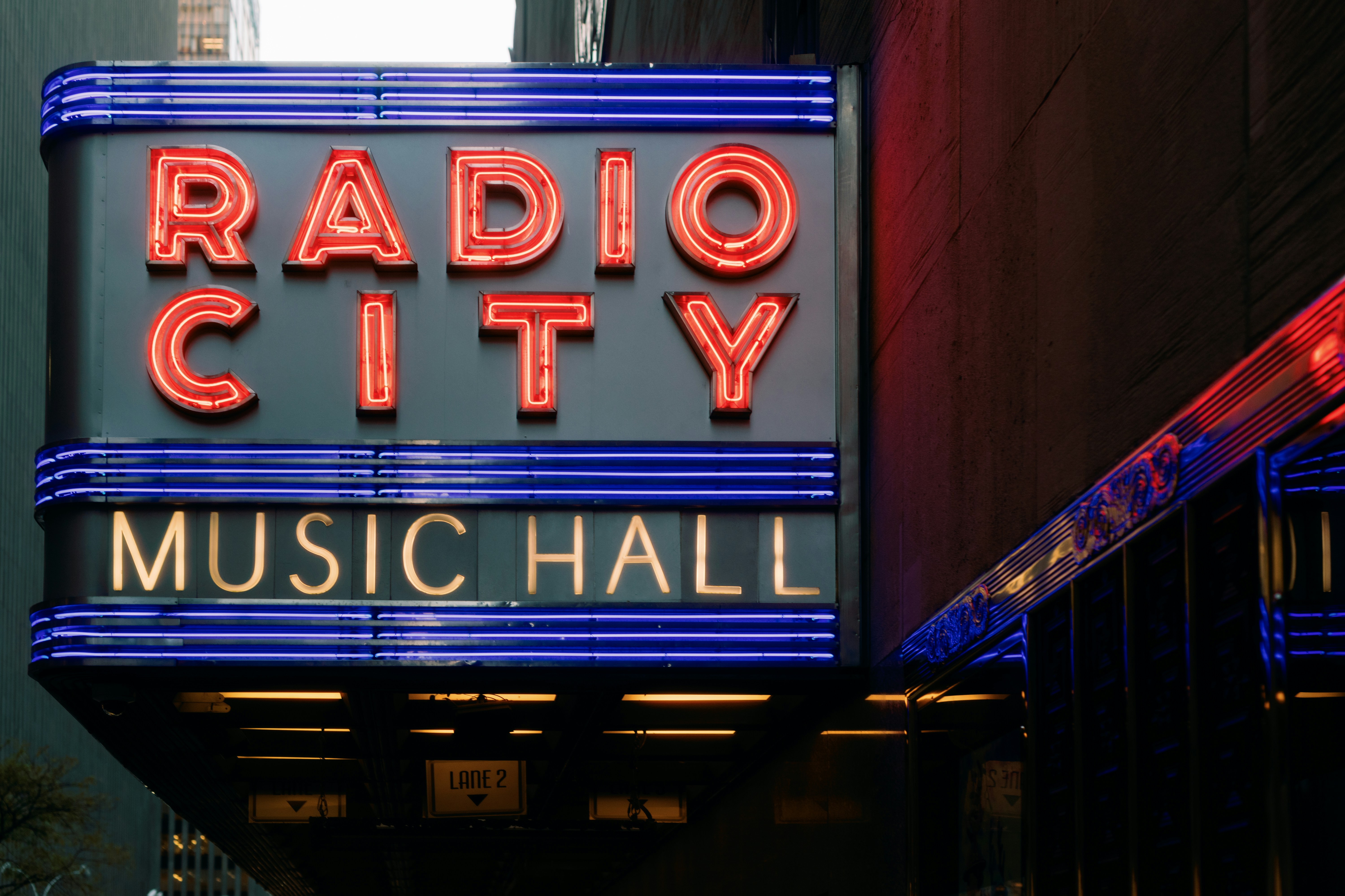 the radio city music hall sign is lit up