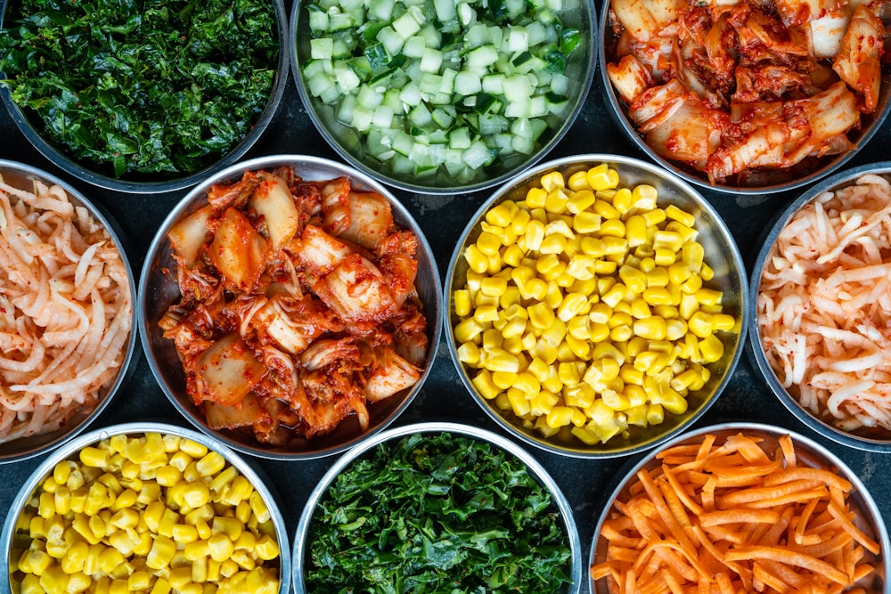 a bunch of bowls filled with different types of food