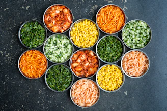 a group of tins filled with different types of food