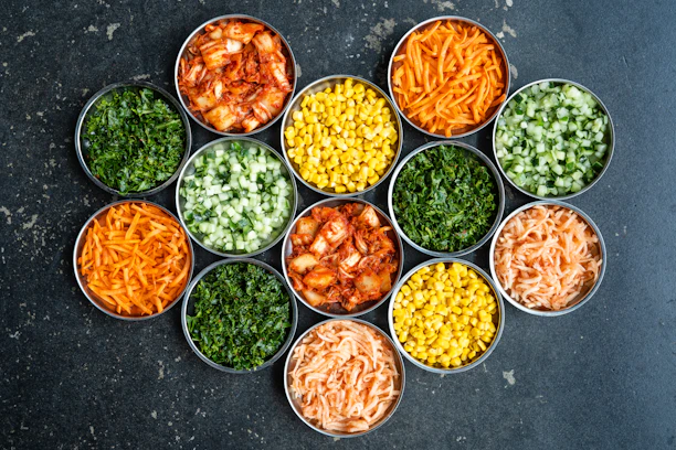a group of tins filled with different types of food