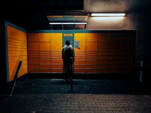 A friendly staff member packing a brightly colored DHL box behind a service counter.