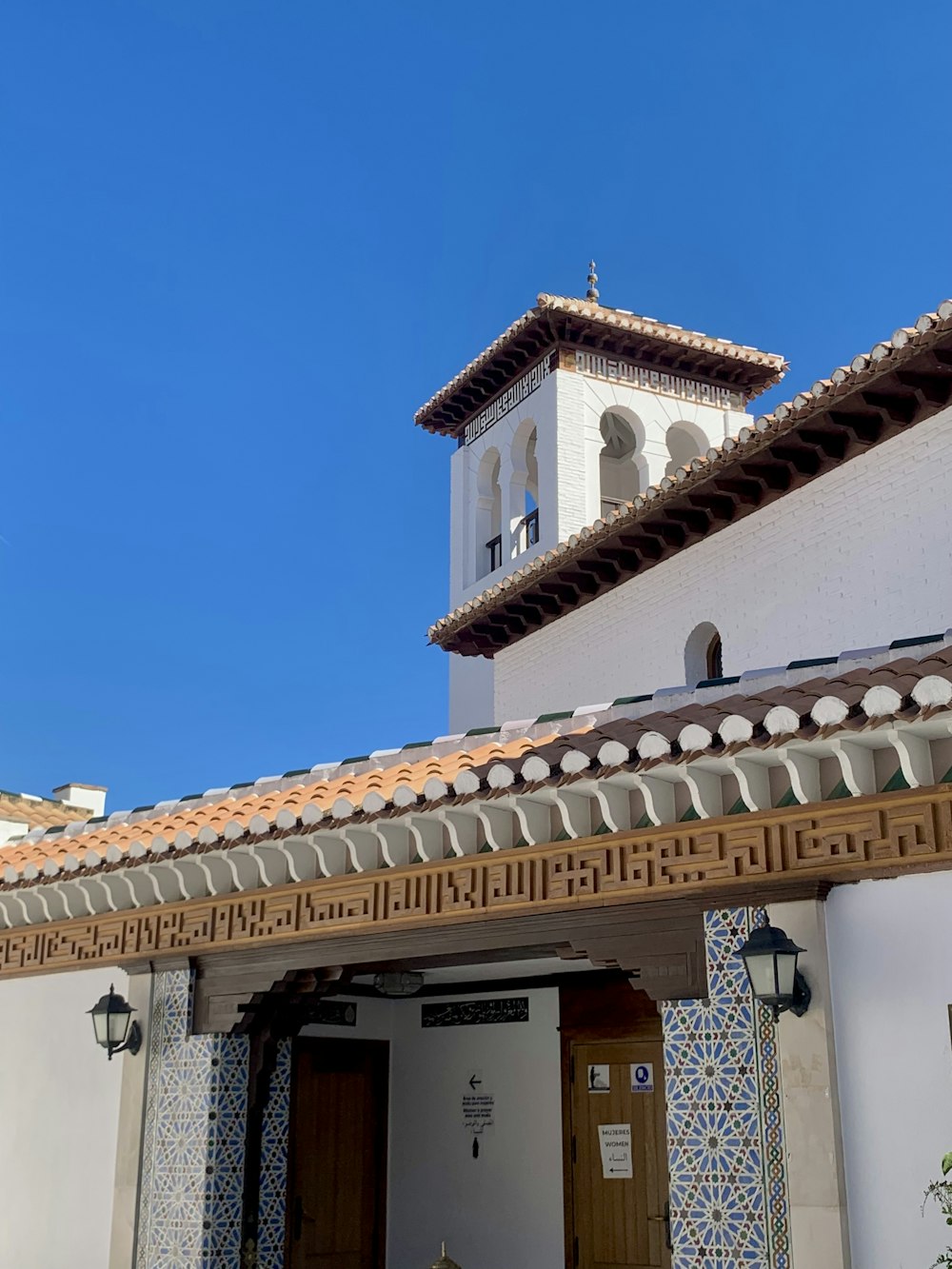 a white building with a clock tower on top of it