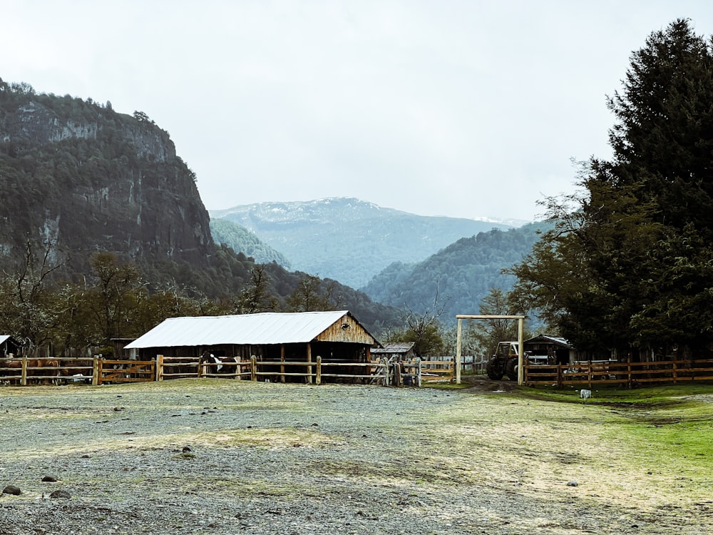 a farm with mountains in the background