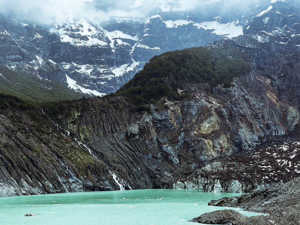 a mountain range with a lake in the foreground