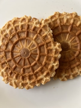 Close-up of edible cookies with delicate engraved designs.