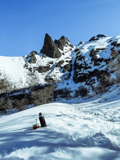 a man standing on top of a snow covered slope