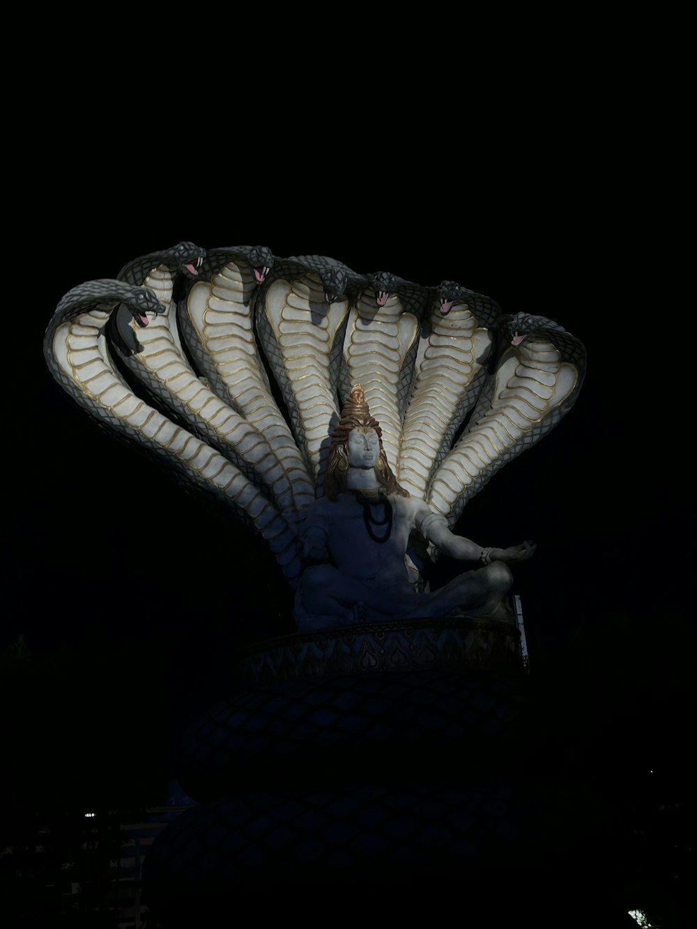 a statue of a woman sitting on top of a shell