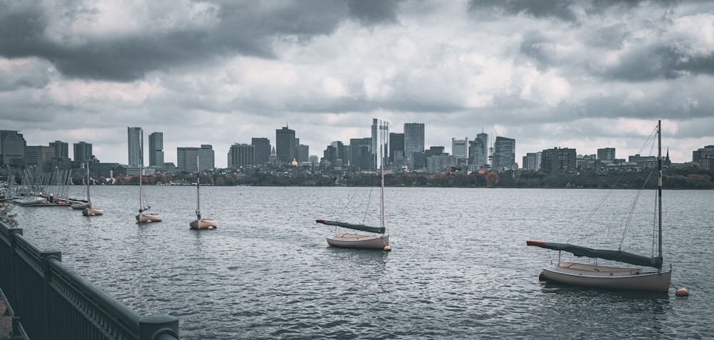 a group of sailboats floating on top of a body of water