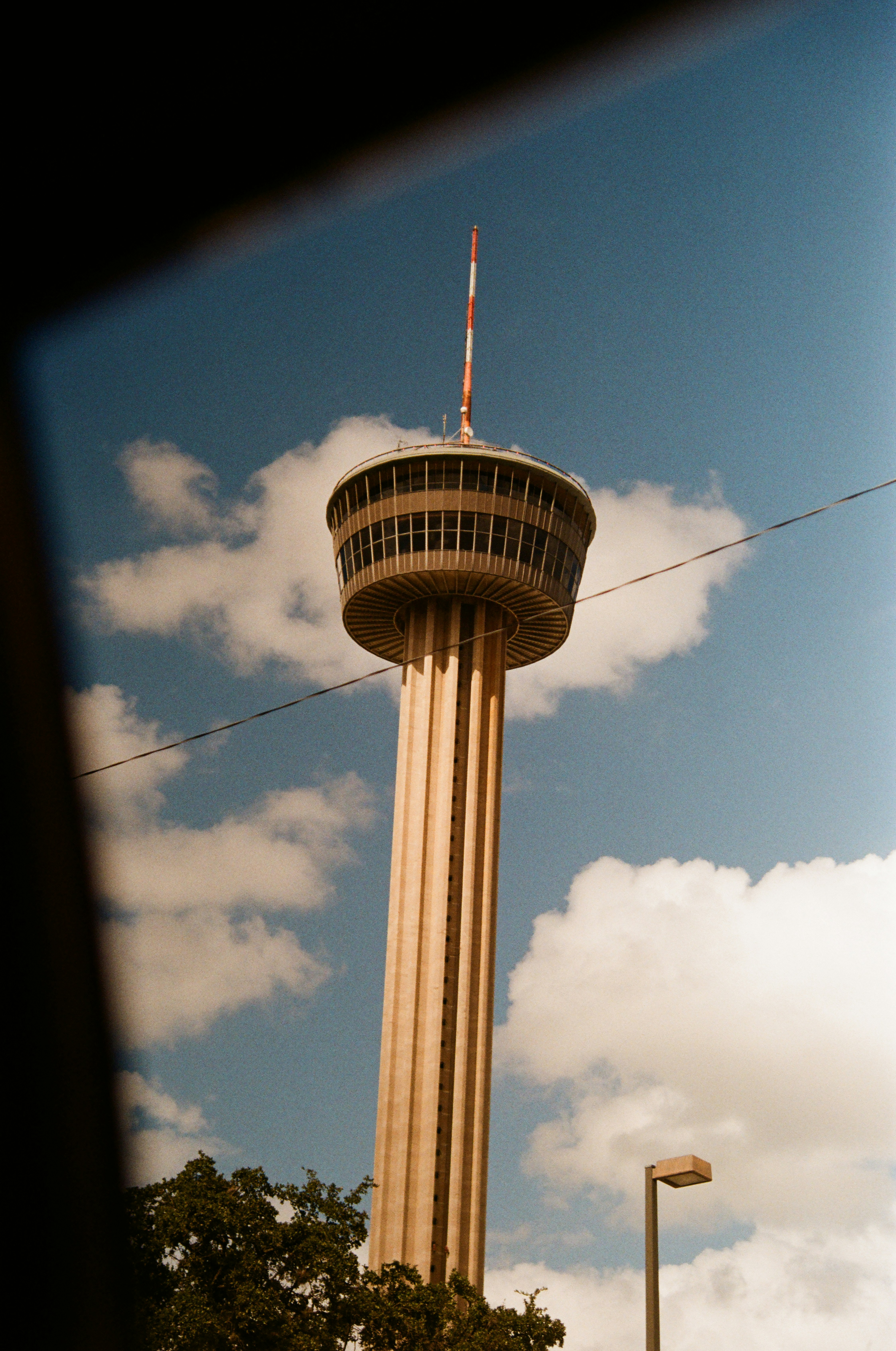 a tall tower with a flag on top of it