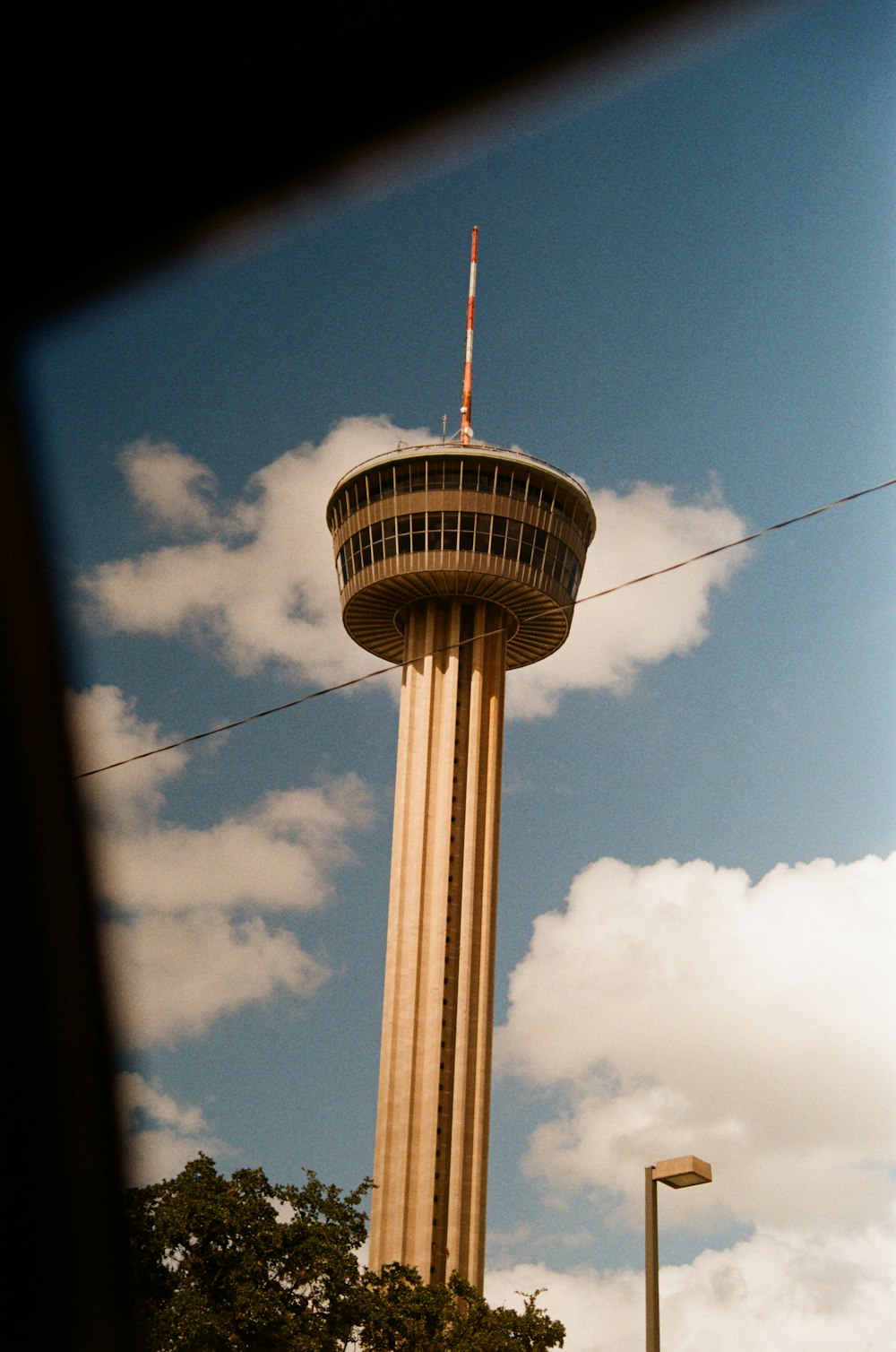 a tall tower with a flag on top of it