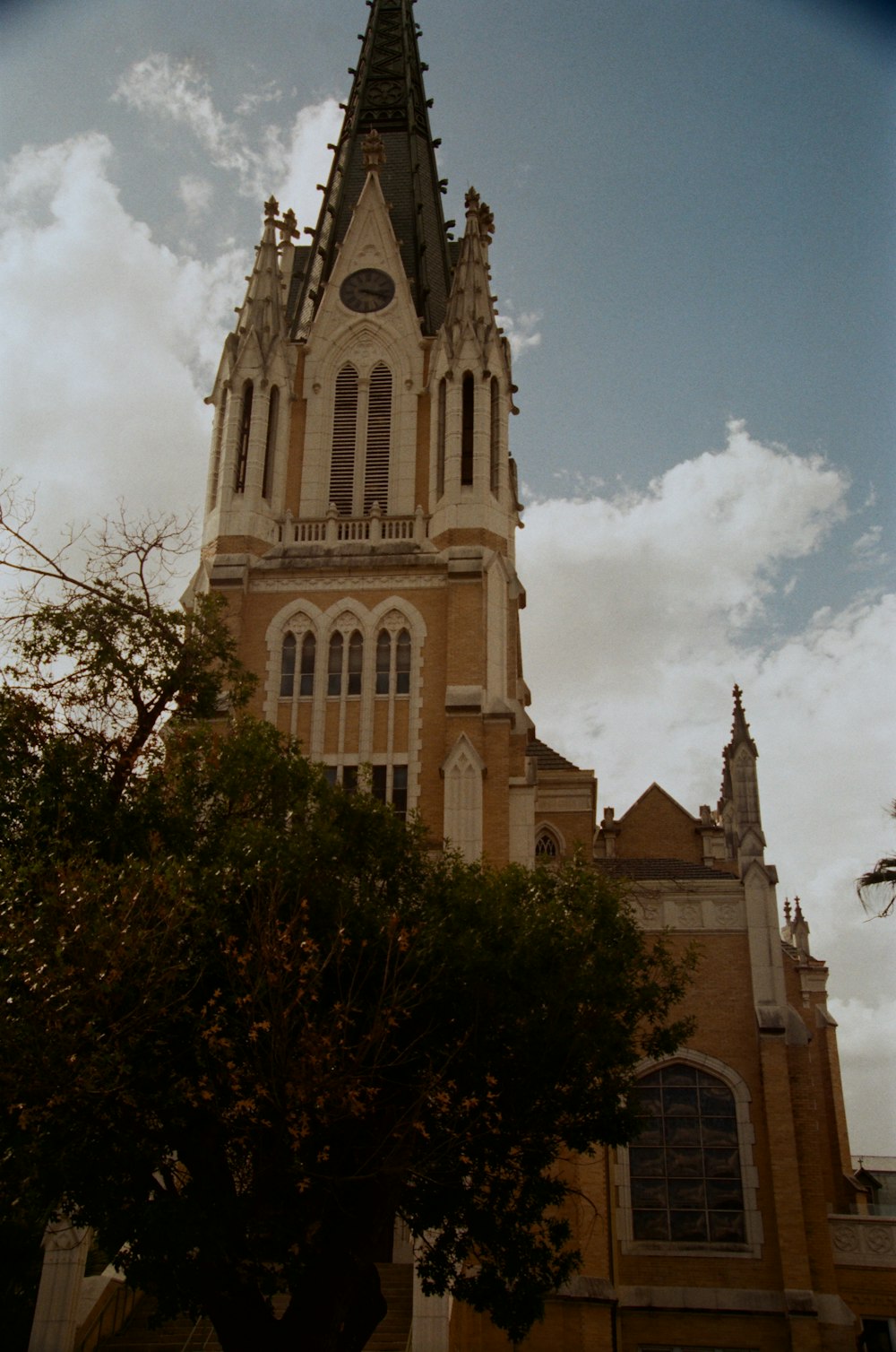 a large church with a steeple on a cloudy day