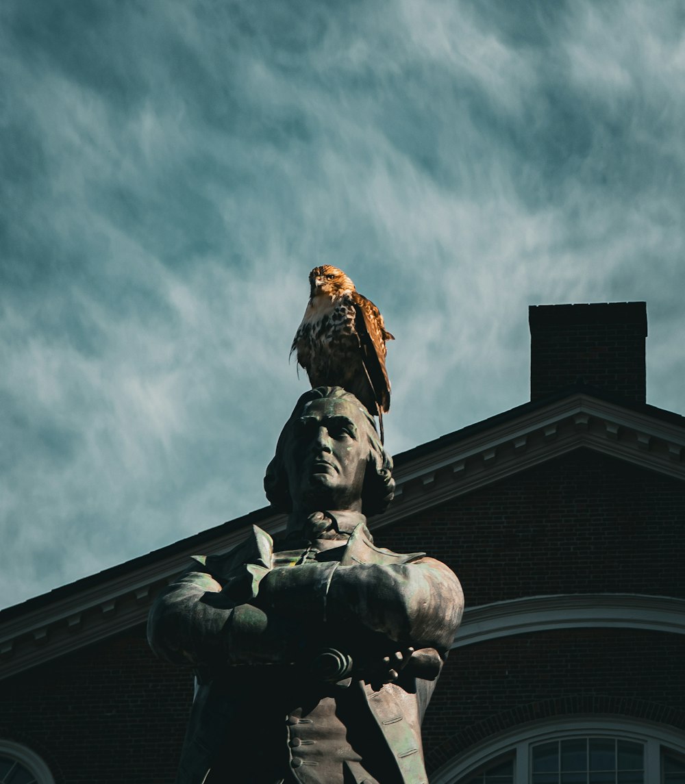 a statue of a man with an eagle on his head