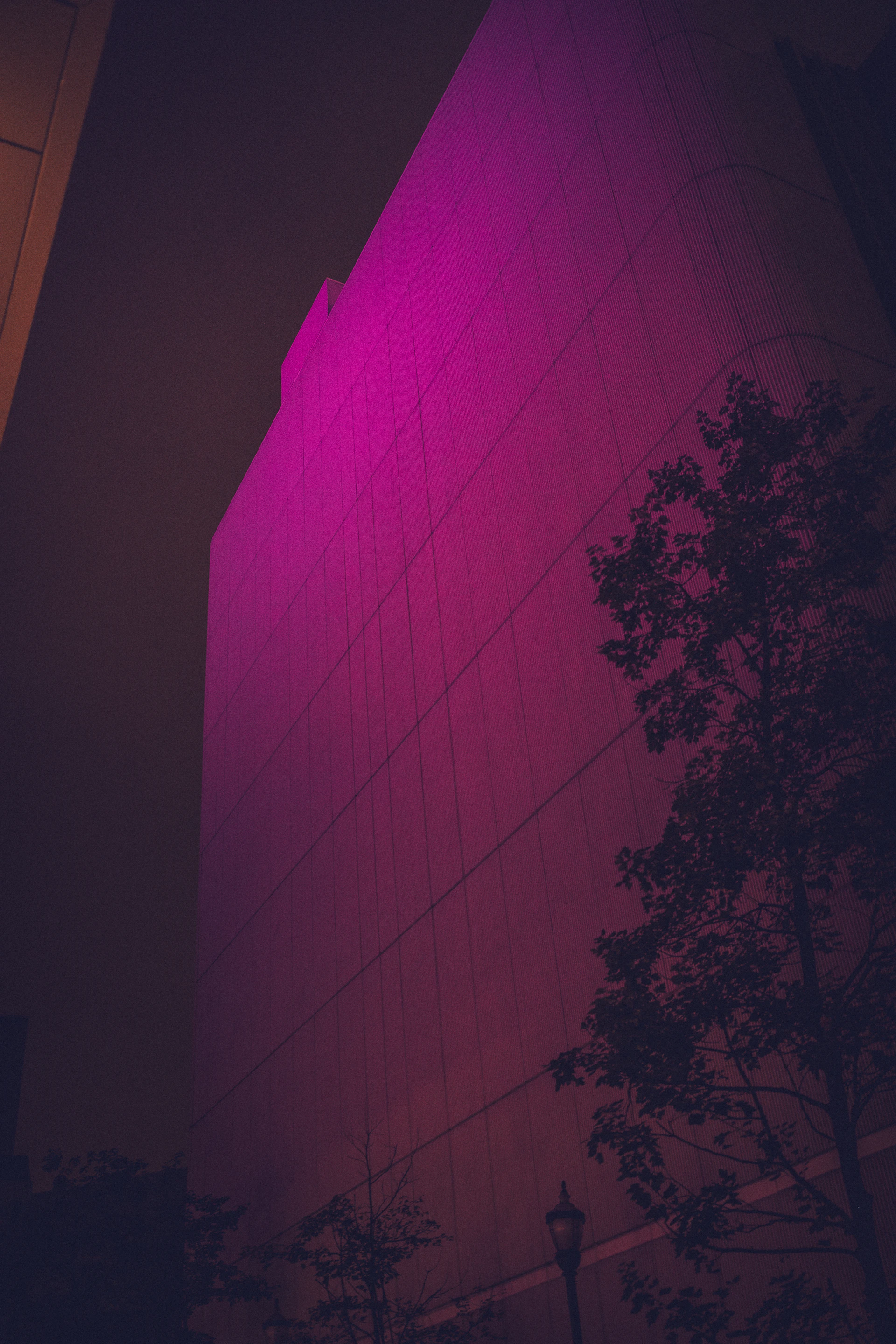 a tall building with a purple light on it's side