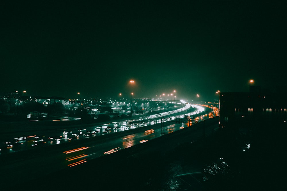 a night time view of a highway with a lot of traffic