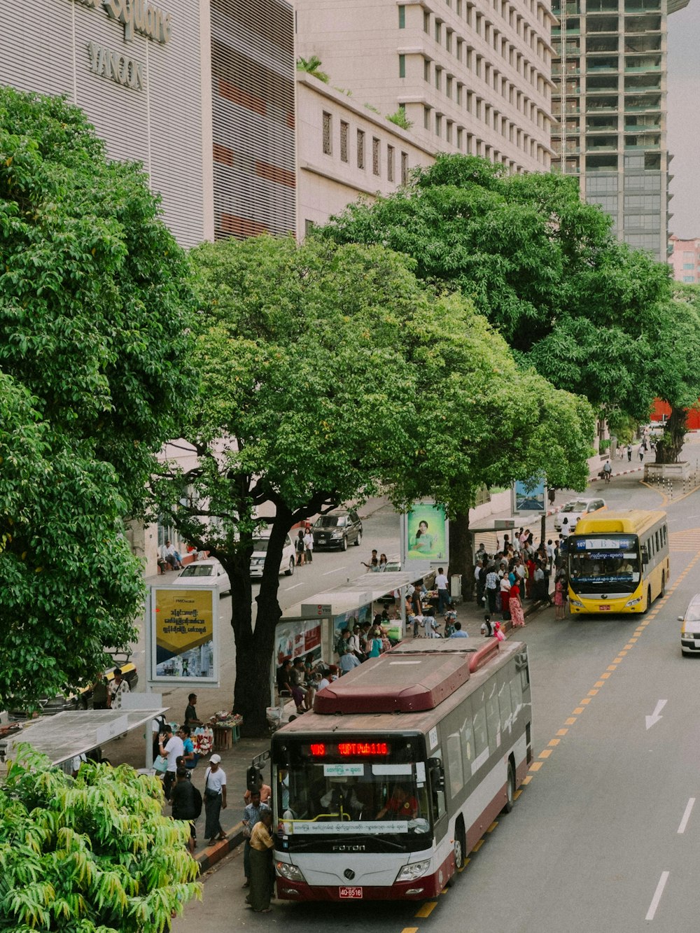 a city street filled with lots of traffic next to tall buildings