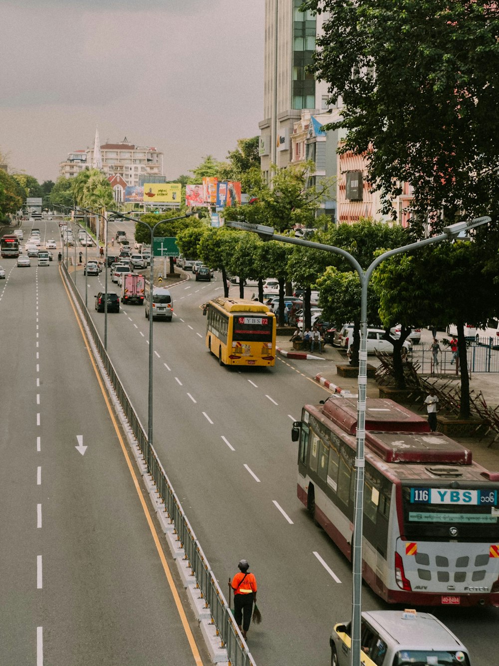 a man riding a bike down a street next to traffic