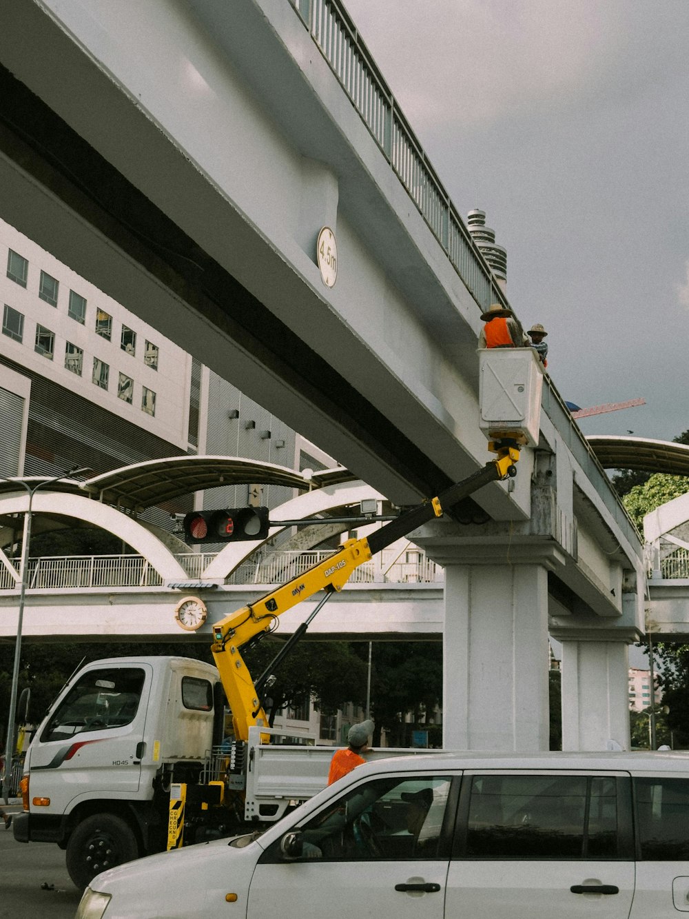 a crane is attached to the side of a bridge