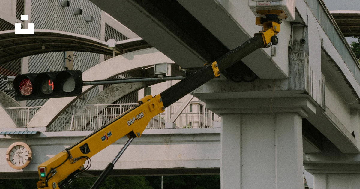 Clock On Bridge A crane is holding up a clock on a bridge photo – Free Myanmar Image on ...