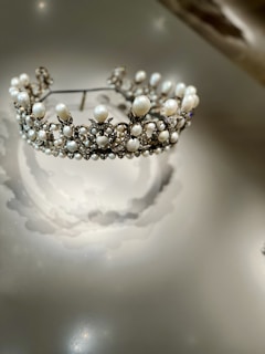 A radiant bridal set featuring a sparkling diamond tiara and matching earrings, glowing softly under warm light.