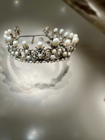 A radiant bridal set featuring a sparkling diamond tiara and matching earrings, glowing softly under warm light.