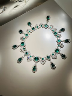 An elegant display of various emeralds in different shapes and sizes.