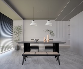 Modern dining area featuring sleek black blinds and minimalist decor