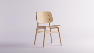 A bespoke wooden chair with sleek lines set against a minimalist white background.
