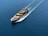 A cargo ship is sailing through a vast expanse of blue water, carrying numerous colorful shipping containers. The ship leaves a trail of waves behind, slicing smoothly through the calm sea.
