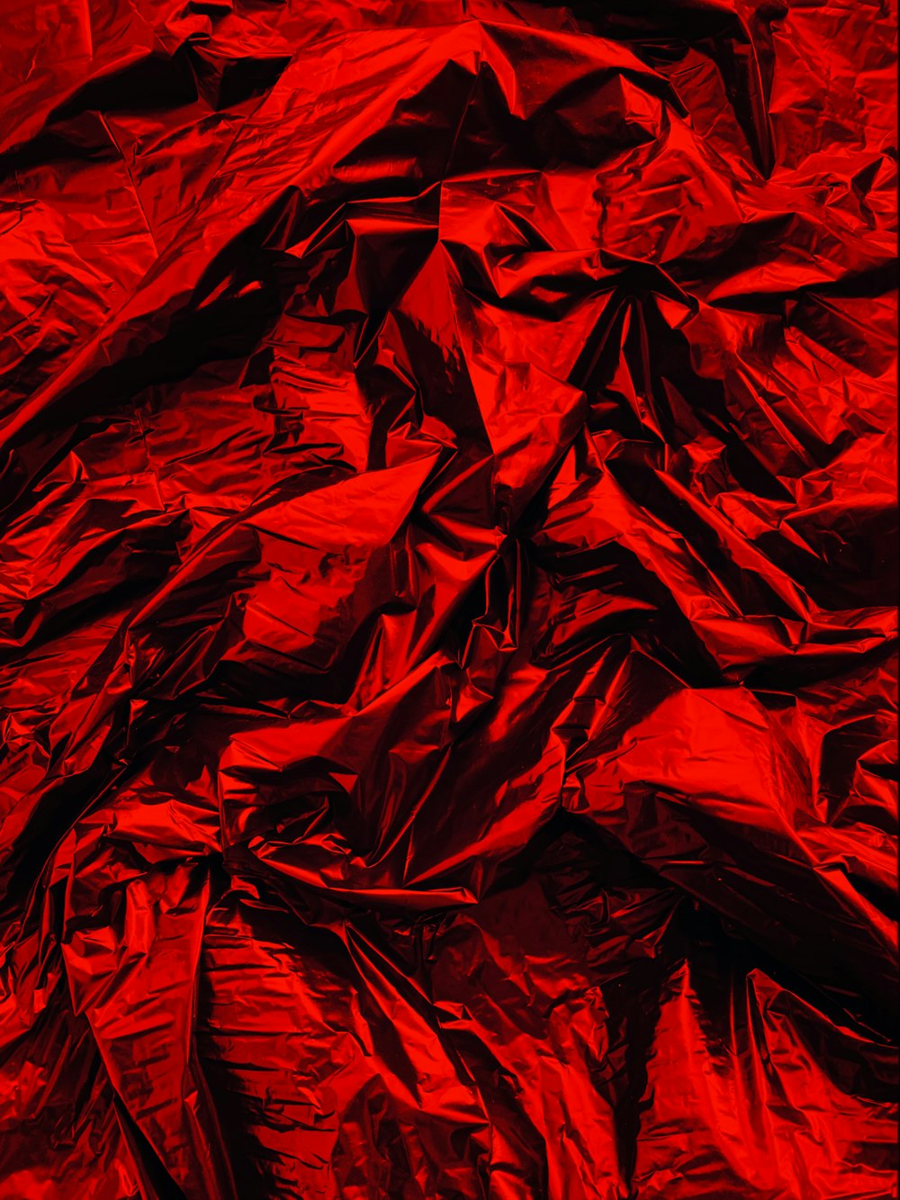 a pile of red crumpled paper sitting on top of a table