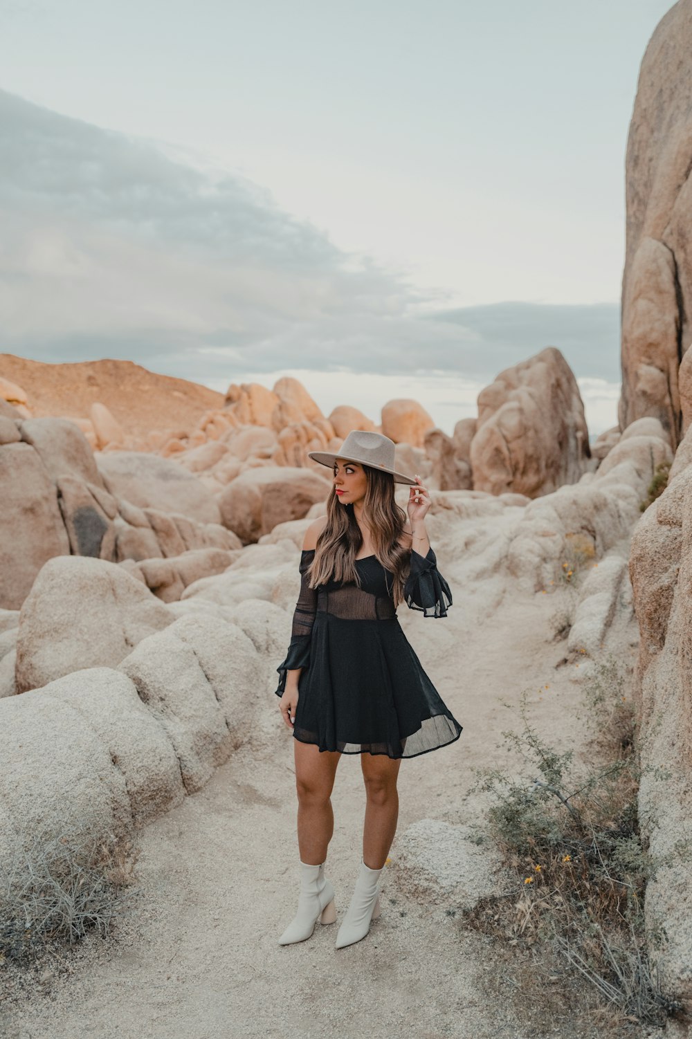 a woman wearing a hat and a black dress