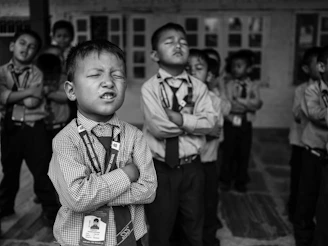 a group of young boys standing next to each other