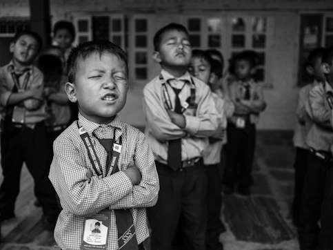 a group of young boys standing next to each other